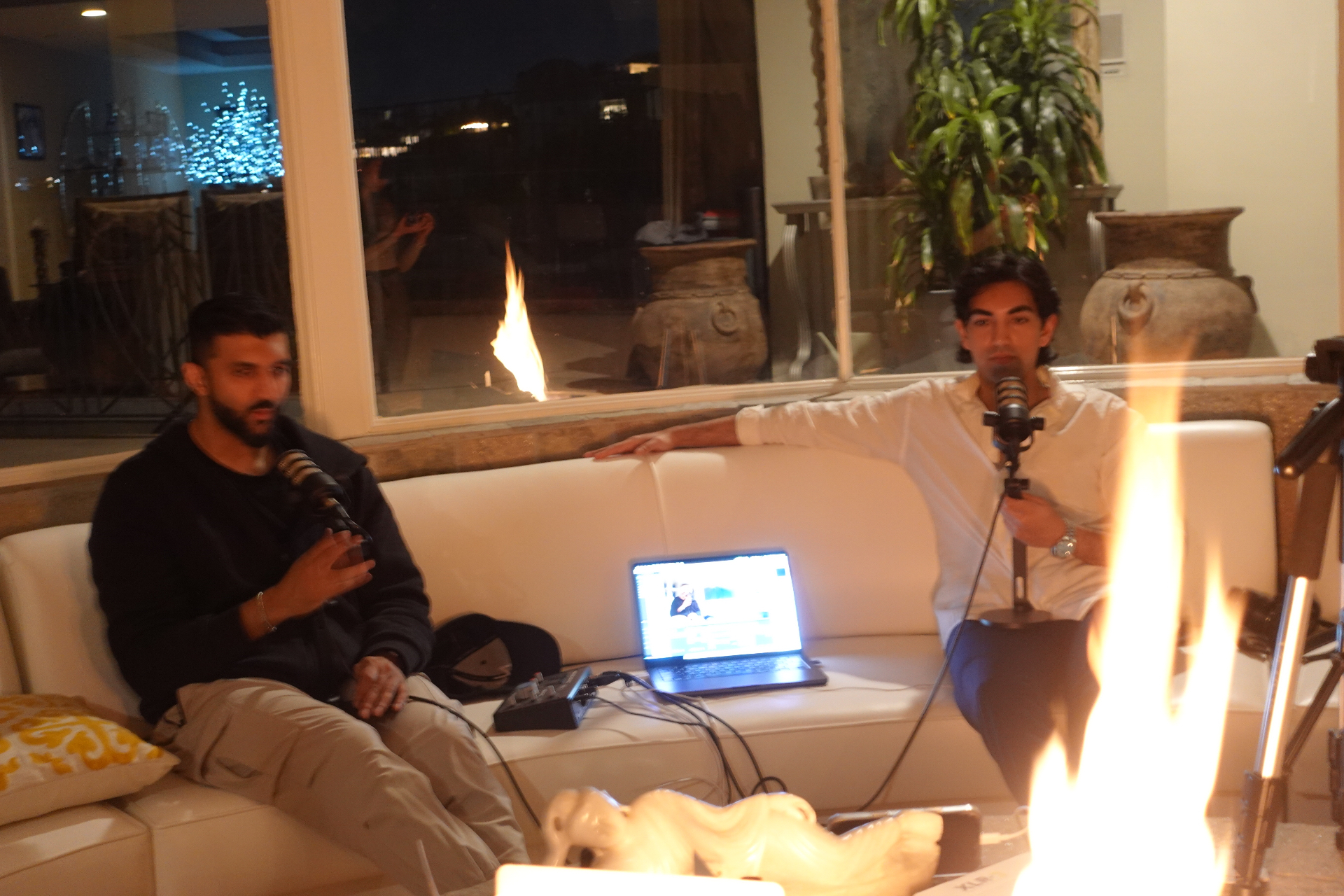 Dr. Shubh Dhruv recording a podcast by the fireplace